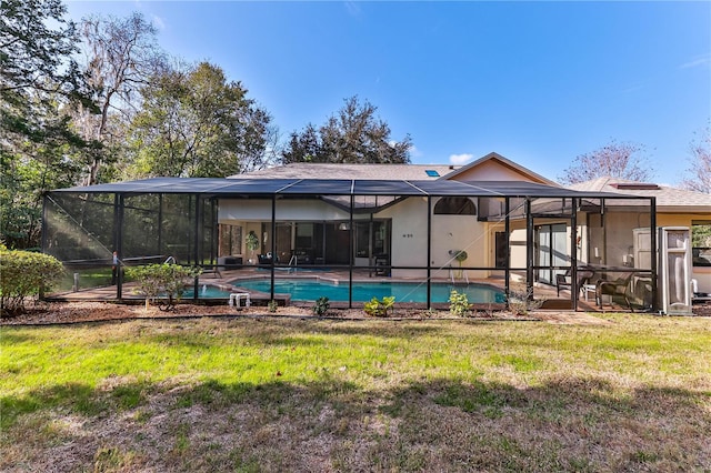 rear view of property with a yard, a patio area, and glass enclosure