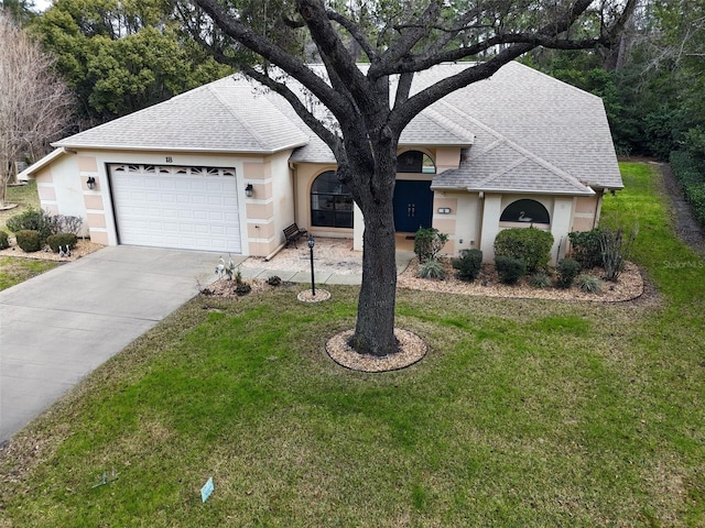 single story home featuring a garage and a front lawn