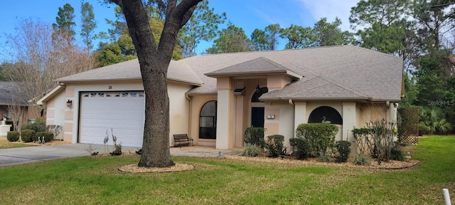 ranch-style house with a garage and a front lawn