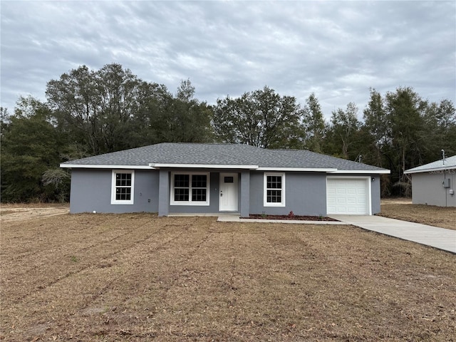 single story home featuring a front yard and a garage