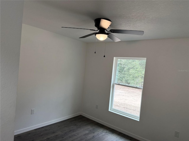 unfurnished room with ceiling fan and dark hardwood / wood-style floors