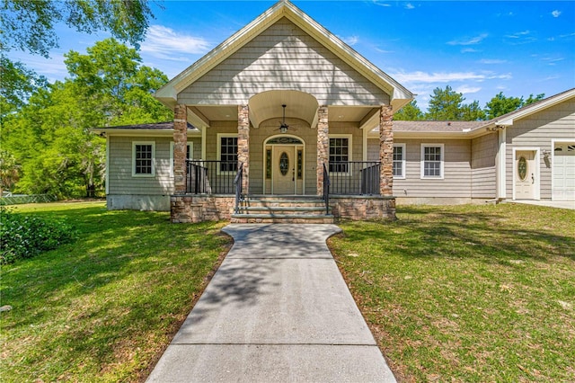 view of front facade featuring a porch, a garage, and a front yard