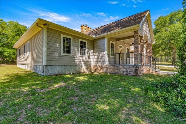 view of side of home with a yard