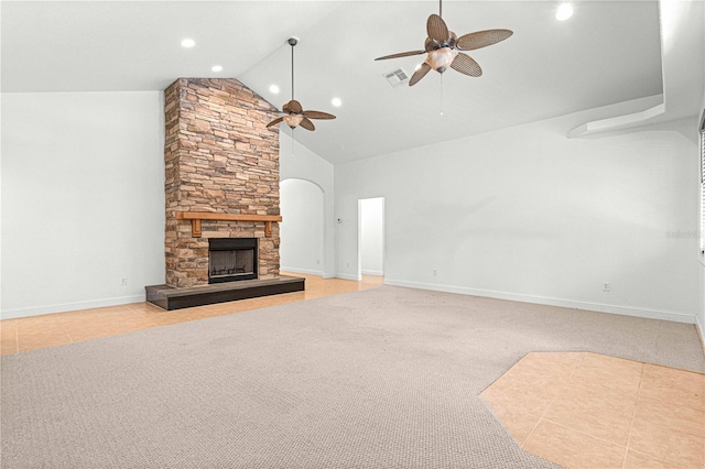 unfurnished living room featuring high vaulted ceiling, a stone fireplace, ceiling fan, and light tile patterned flooring