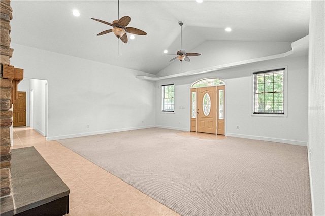 unfurnished living room with a fireplace, light tile patterned floors, plenty of natural light, and ceiling fan