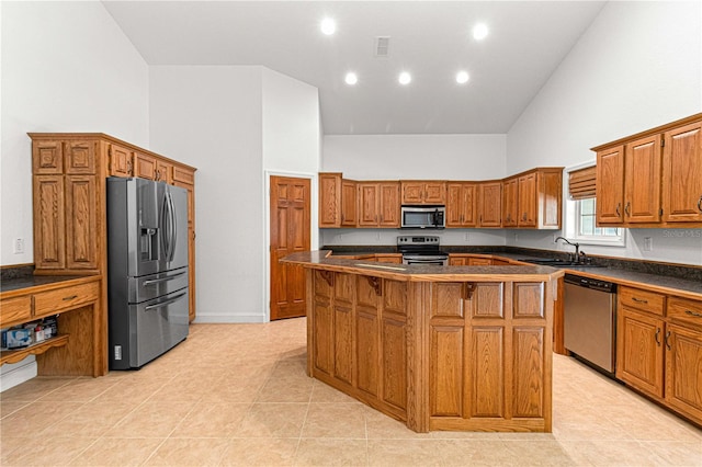 kitchen featuring stainless steel appliances, sink, high vaulted ceiling, a center island, and light tile patterned flooring