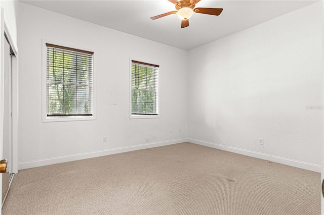 carpeted empty room featuring ceiling fan