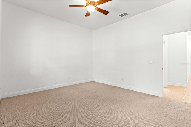 carpeted spare room featuring ceiling fan