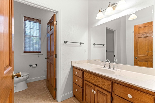 bathroom featuring tile patterned flooring, vanity, and toilet