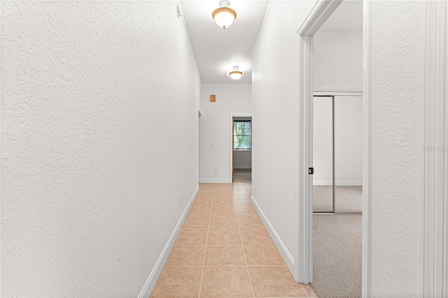 hallway featuring light tile patterned floors