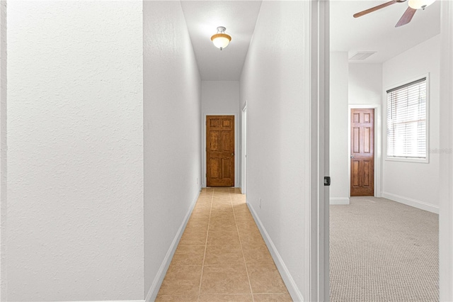 hallway featuring light tile patterned flooring