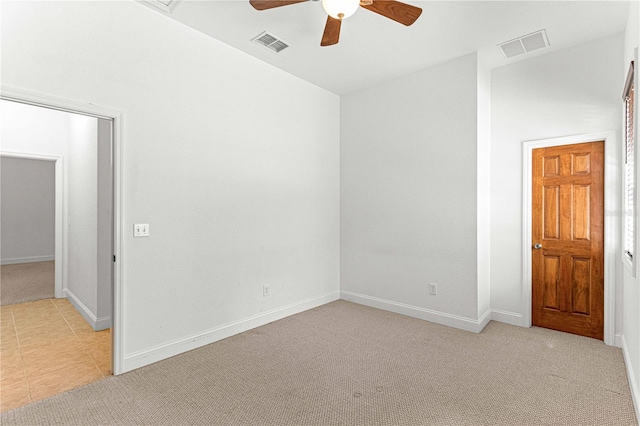 carpeted spare room featuring ceiling fan