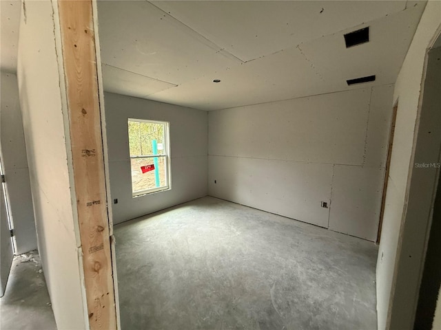 empty room with concrete flooring