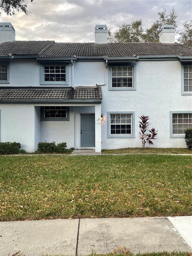 front facade with a front yard