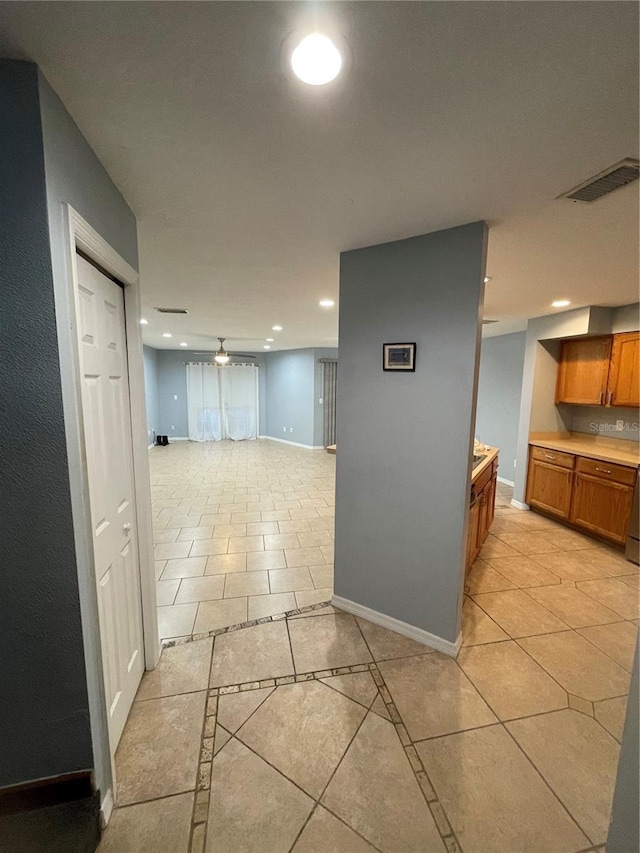 hall featuring light tile patterned flooring