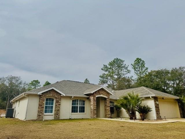 ranch-style house featuring a garage and a front lawn