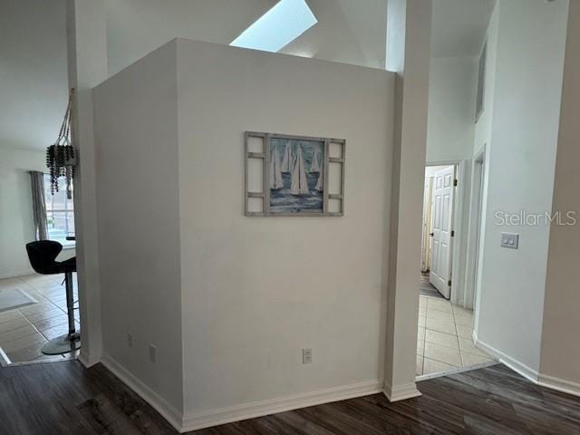 hall featuring a skylight and wood-type flooring