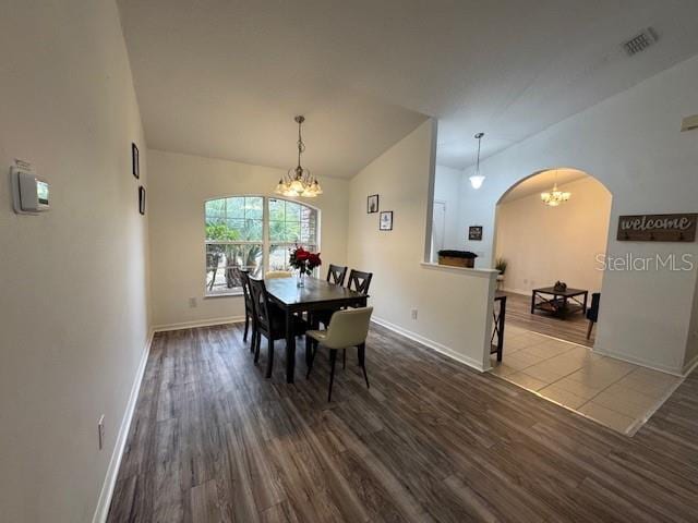 dining room featuring hardwood / wood-style floors and a notable chandelier