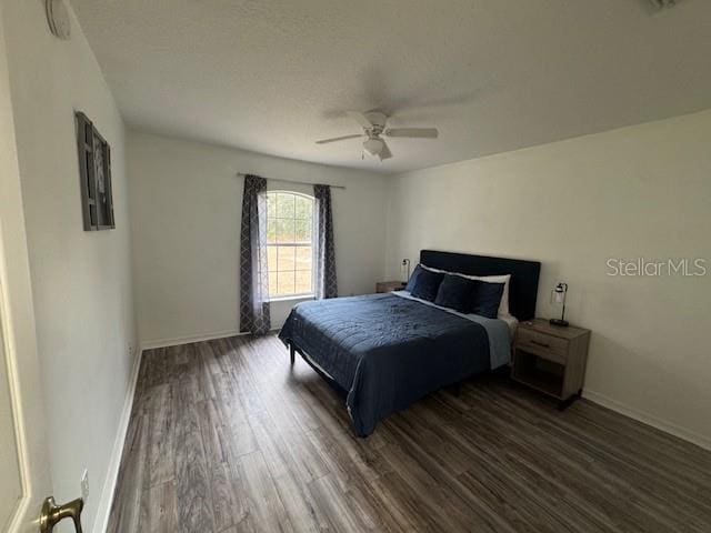 bedroom featuring ceiling fan and dark hardwood / wood-style floors