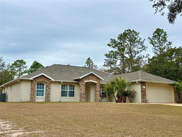 ranch-style house featuring a garage and a front lawn