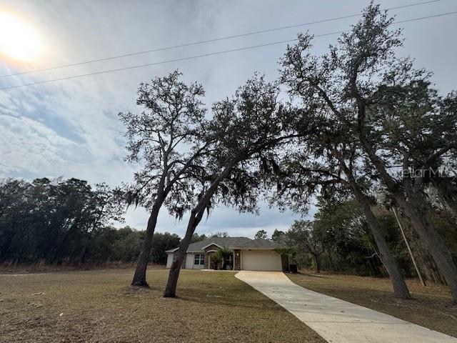 view of front of property with a front yard and a garage