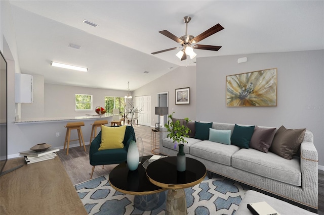 living room with wood-type flooring, ceiling fan with notable chandelier, and lofted ceiling