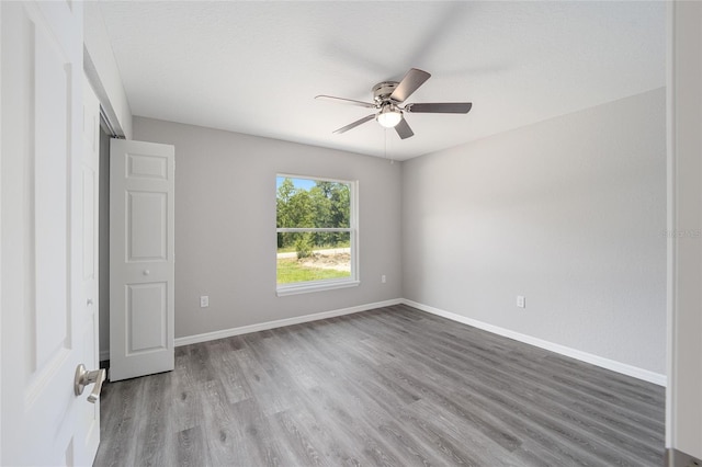 unfurnished bedroom featuring hardwood / wood-style floors and ceiling fan