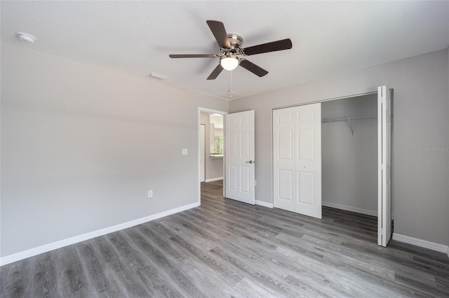 unfurnished bedroom featuring hardwood / wood-style flooring, ceiling fan, and a closet