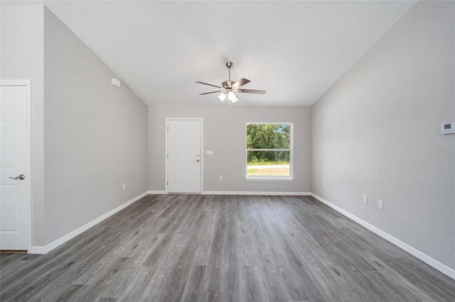 unfurnished room with ceiling fan and dark wood-type flooring