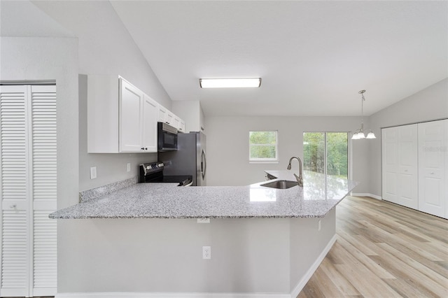 kitchen featuring lofted ceiling, white cabinets, decorative light fixtures, kitchen peninsula, and stainless steel appliances