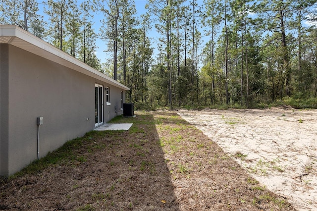 view of yard featuring central air condition unit