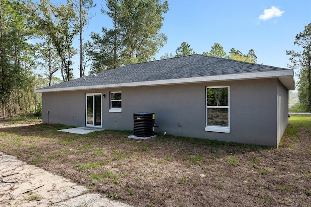 back of house featuring central air condition unit