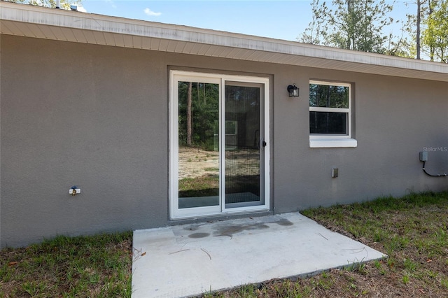 property entrance featuring a patio