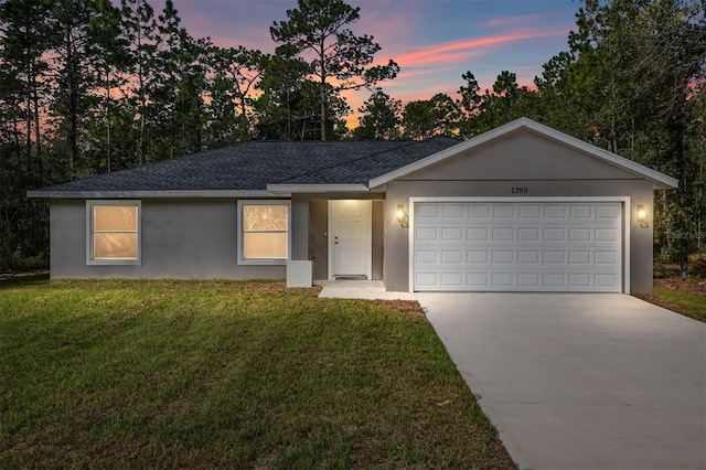 single story home with a lawn and a garage