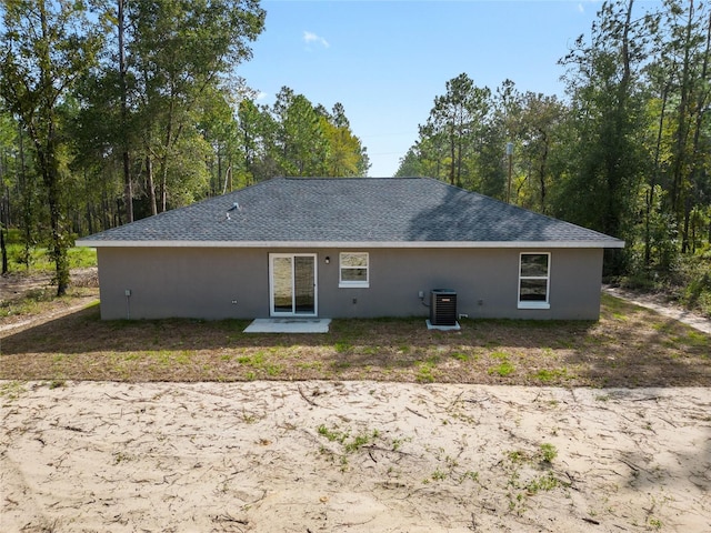 rear view of property featuring central AC unit