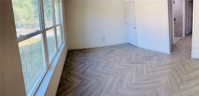 spare room with baseboards