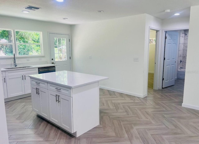 kitchen with recessed lighting, a sink, visible vents, white cabinetry, and light countertops
