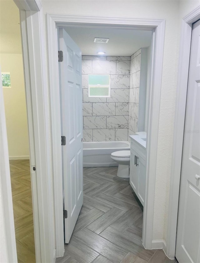 full bathroom featuring toilet, shower / bathtub combination, visible vents, and vanity