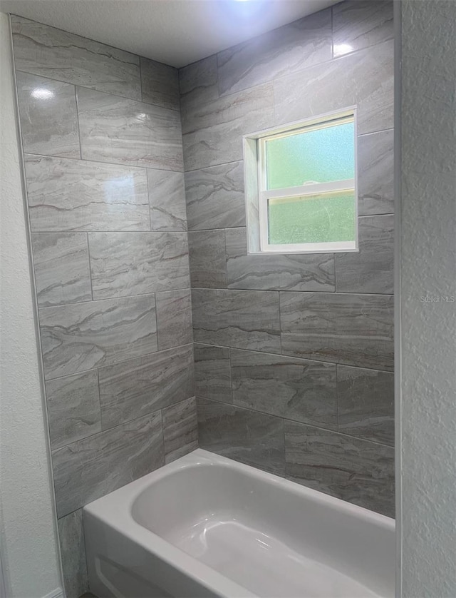 bathroom with bathing tub / shower combination