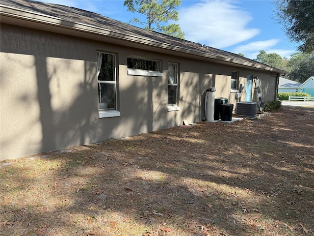 view of side of home featuring central AC