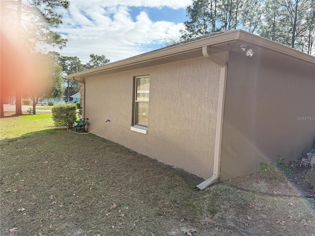 view of side of home with a lawn