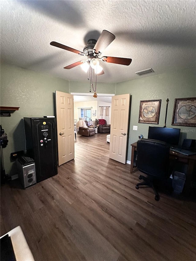 office space with ceiling fan, dark wood-type flooring, and a textured ceiling