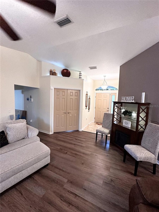 living room featuring dark hardwood / wood-style floors and a textured ceiling