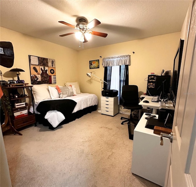 carpeted bedroom featuring ceiling fan and a textured ceiling