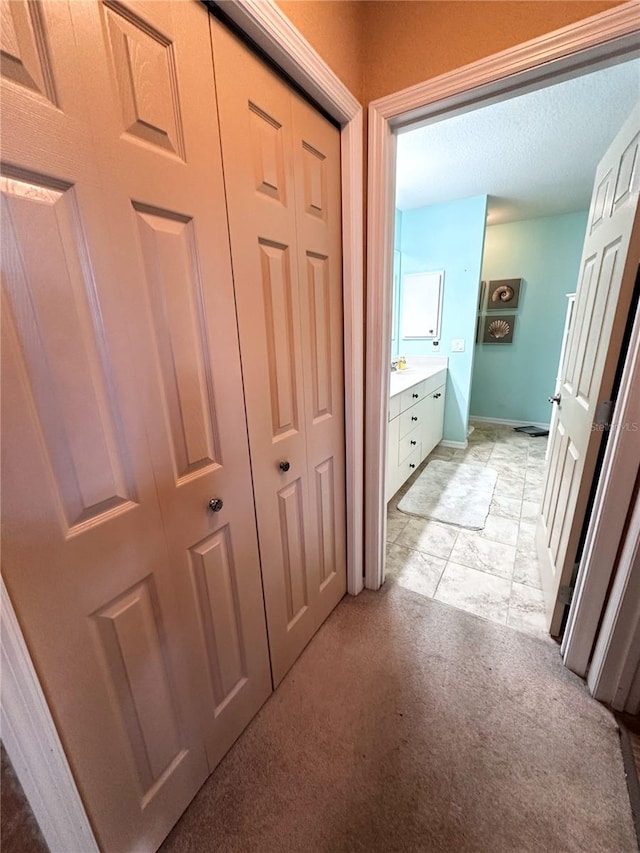 hallway with light colored carpet