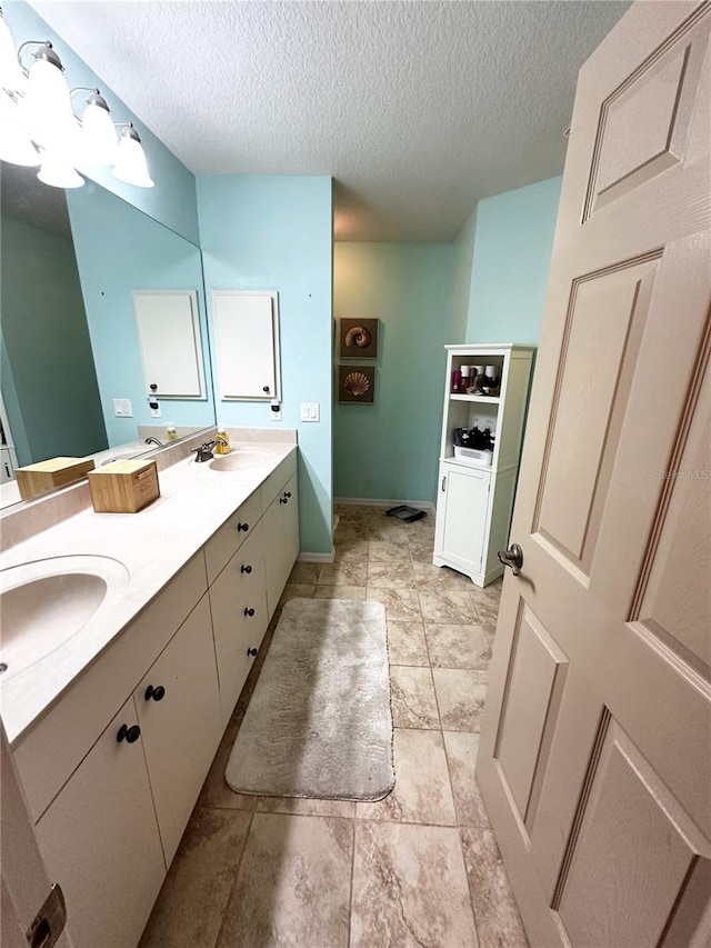 bathroom with a textured ceiling and vanity