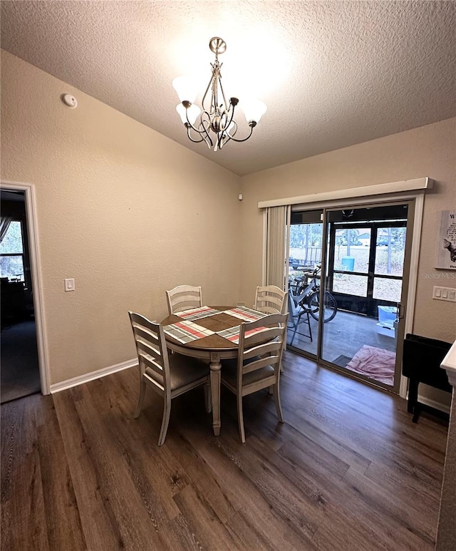 dining room with an inviting chandelier, a textured ceiling, and dark hardwood / wood-style flooring