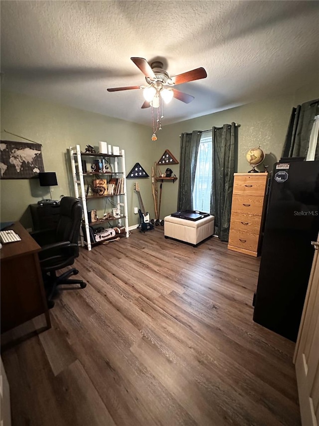 office featuring ceiling fan, a textured ceiling, and dark hardwood / wood-style flooring