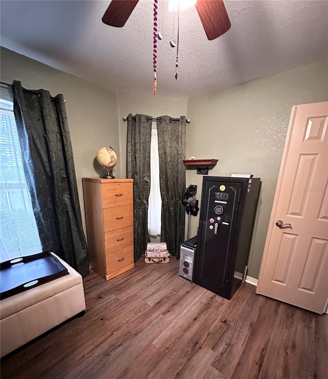 bedroom with a textured ceiling and dark hardwood / wood-style flooring