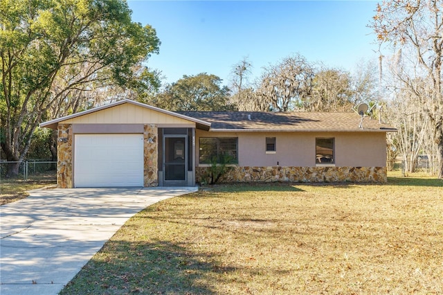 single story home with a garage and a front lawn